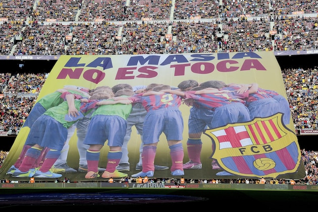 Barcelona's supporters unveil a giant banner reading in Catalan 'La Masia, don't touch it' before the Spanish league football match FC Barcelona vs Real Betis at the Camp Nou stadium in Barcelona.  AFP PHOTO / JOSEP LAGO        (Photo credit should read JOSEP LAGO/AFP/Getty Images)