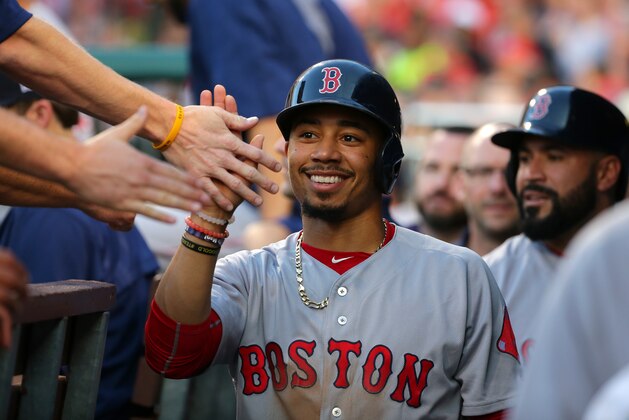 PHILADELPHIA, PA - JUNE 14: Mookie Betts #50 of the Boston Red Sox smiles as he high fives teammates after scoring a run in the second inning during a game against the Philadelphia Phillies at Citizens Bank Park on June 14, 2017 in Philadelphia, Pennsylvania. (Photo by Hunter Martin/Getty Images)