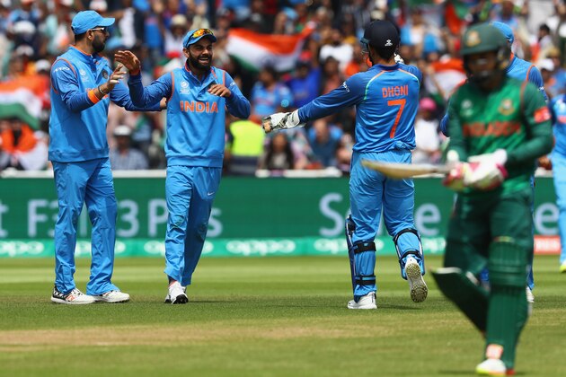 BIRMINGHAM, ENGLAND - JUNE 15:  Virat Kohli (2L) of India celebrates taking a catch off the bowling of Kedar Jadhav to claim the wicket of Mushfiqur Rahim of Bangladesh during the ICC Champions Trophy Semi-Final match between Bangladesh and India at Edgbaston on June 15, 2017 in Birmingham, England.  (Photo by Michael Steele/Getty Images)