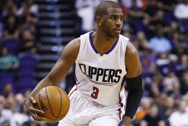 Los Angeles Clippers' Chris Paul dribbles the ball against the Phoenix Suns during the first half of an NBA basketball game Thursday, March 30, 2017, in Phoenix. (AP Photo/Ross D. Franklin)