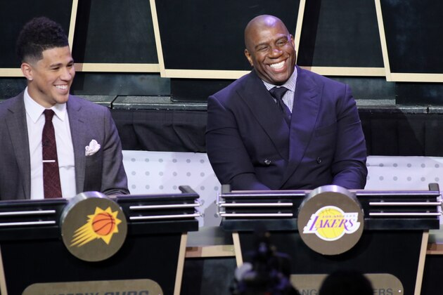 NEW YORK, NEW YORK - MAY 16:  Magic Johnson of the Los Angeles Lakers and Devin Booker #1 of the Phoenix Suns smile during the 2017 NBA Draft Lottery at the New York Hilton in New York, New York. NOTE TO USER: User expressly acknowledges and agrees that, by downloading and or using this Photograph, user is consenting to the terms and conditions of the Getty Images License Agreement.  Mandatory Copyright Notice: Copyright 2017 NBAE (Photo by Michael J. Lebrecht II/NBAE via Getty Images)