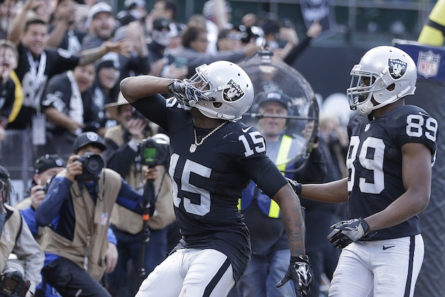 Oakland Raiders wide receiver Michael Crabtree (15) celebrates after scoring a touchdown with wide receiver Amari Cooper (89) during the second half of an NFL football game against the Buffalo Bills in Oakland, Calif., Sunday, Dec. 4, 2016. (AP Photo/Ben Margot)