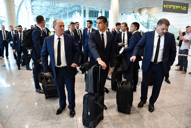 Australian national football team head coach Ange Postecoglou (R), Australia's forward Tim Cahill (C), arrive with the team at the Domodedovo International airport outside Moscow on June 15, 2017, ahead of the 2017 FIFA Confederations Cup football tournament in Russia.   / AFP PHOTO / Alexander NEMENOV        (Photo credit should read ALEXANDER NEMENOV/AFP/Getty Images)