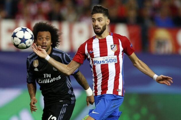 Atletico Madrid's Yannick Carrasco, right, Real Madrid's Marcelo go for the ball during the Champions League semifinal second leg soccer match between Atletico Madrid and Real Madrid at the Vicente Calderon stadium in Madrid, Wednesday, May 10, 2017. (AP Photo/Francisco Seco)