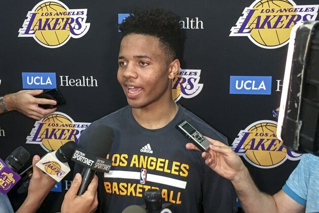 Markelle Fultz, center, speaks with reporters after his private workout with the Los Angeles Lakers at NBA basketball team's training complex Thursday, June 15, 2017, in El Segundo, Calif. The University of Washington guard could be the No. 1 pick in the NBA draft by the Boston Celtics, or he could be available to the Los Angeles Lakers with the second overall pick. (AP Photo/Greg Beacham)