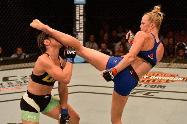 SINGAPORE - JUNE 17:   (R-L) Holly Holm knocks out Bethe Correia of Brazil with a kick in their women's bantamweight bout during the UFC Fight Night event at the Singapore Indoor Stadium on June 17, 2017 in Singapore. (Photo by Brandon Magnus/Zuffa LLC/Zuffa LLC via Getty Images)