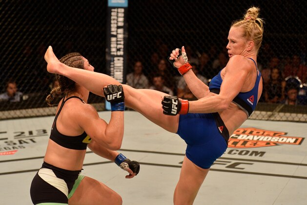 SINGAPORE - JUNE 17:   Holly Holm knocks out Bethe Correia of Brazil with a kick in their women's bantamweight bout during the UFC Fight Night event at the Singapore Indoor Stadium on June 17, 2017 in Singapore. (Photo by Brandon Magnus/Zuffa LLC/Zuffa LLC via Getty Images)