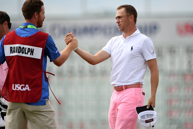Jun 17, 2017; Erin, WI, USA;  Justin Thomas greets playing partner Jonathan Randolph's caddie David Dubord on the 18th green following their third round of the U.S. Open golf tournament at Erin Hills. Mandatory Credit: Michael Madrid-USA TODAY Sports