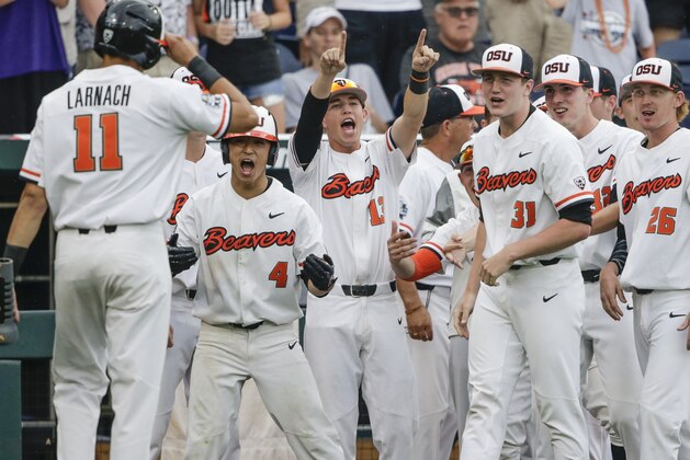 Oregon State designated hitter Trevor Larnach (11) is greeted by teammates including Steven Kwan (4) and George Mendazona (13) after he scored the go-ahead run on a one-run single by Adley Rutschman against Cal State Fullerton in the eighth inning of an NCAA men's College World Series baseball game in Omaha, Neb., Saturday, June 17, 2017. (AP Photo/Nati Harnik) Oregon State designated hitter Trevor Larnach (11) is greeted by teammates including Steven Kwan (4) and George Mendazona (13) after he scored the go-ahead run on a one-run single by Adley Rutschman against Cal State Fullerton in the eighth inning of an NCAA men's College World Series baseball game in Omaha, Neb., Saturday, June 17, 2017. (AP Photo/Nati Harnik)
