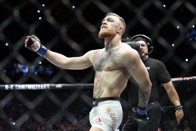 Nov 12, 2016; New York, NY, USA;  Conor McGregor (blue gloves) before fighting Eddie Alvarez (red gloves) in their lightweight title bout during UFC 205 at Madison Square Garden. Mandatory Credit: Adam Hunger-USA TODAY Sports
