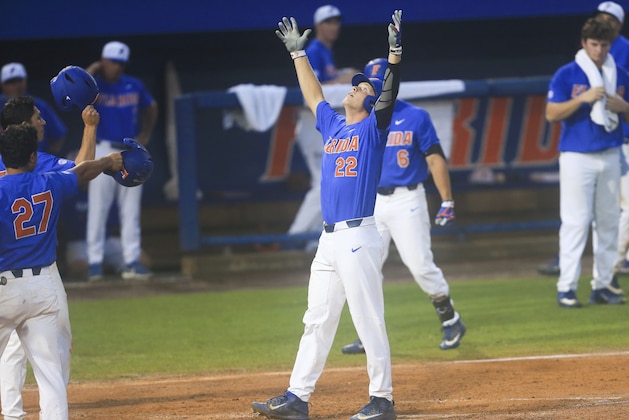 Florida batter JJ Schwarz (22) celebrates at home plate after hitting a two-run home run in the third inning of an NCAA college super regional baseball game against Wake Forest on Monday, June 12, 2017, in Gainesville, Fla. (AP Photo/Matt Stamey)
