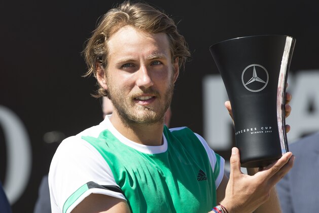 France's Lucas Pouille holds up the trophy after defeating Spain's Feliciano Lopez (not in picture) in the final match at the ATP Mercedes Cup tennis tournament in Stuttgart, southwestern Germany, on June 18, 2017.   / AFP PHOTO / THOMAS KIENZLE        (Photo credit should read THOMAS KIENZLE/AFP/Getty Images)