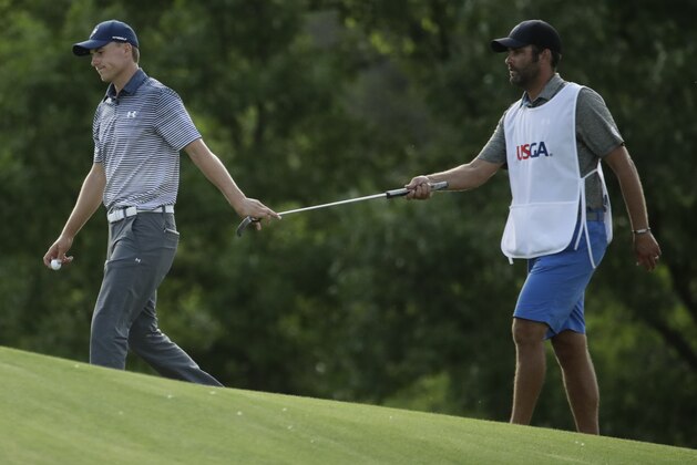 Jordan Spieth is handed a putter on the 15th hole during the second round of the U.S. Open golf tournament Friday, June 16, 2017, at Erin Hills in Erin, Wis. (AP Photo/Charlie Riedel)