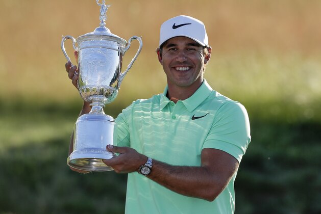Brooks Koepka poses with the winning trophy after the U.S. Open golf tournament Sunday, June 18, 2017, at Erin Hills in Erin, Wis. (AP Photo/Chris Carlson)