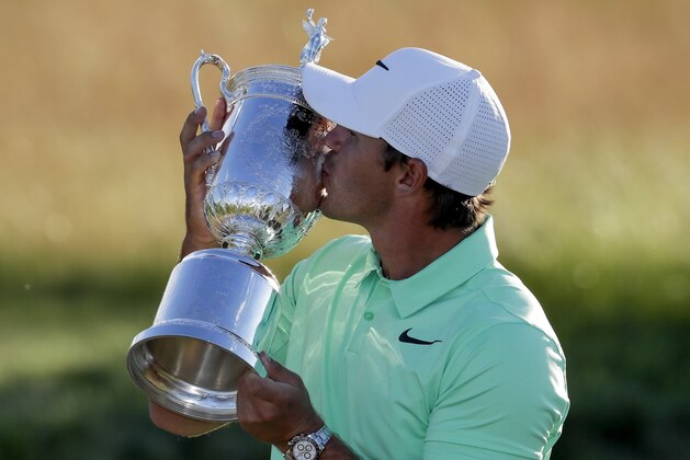 Brooks Koepka kisses the winning trophy after the U.S. Open golf tournament Sunday, June 18, 2017, at Erin Hills in Erin, Wis. (AP Photo/Chris Carlson)