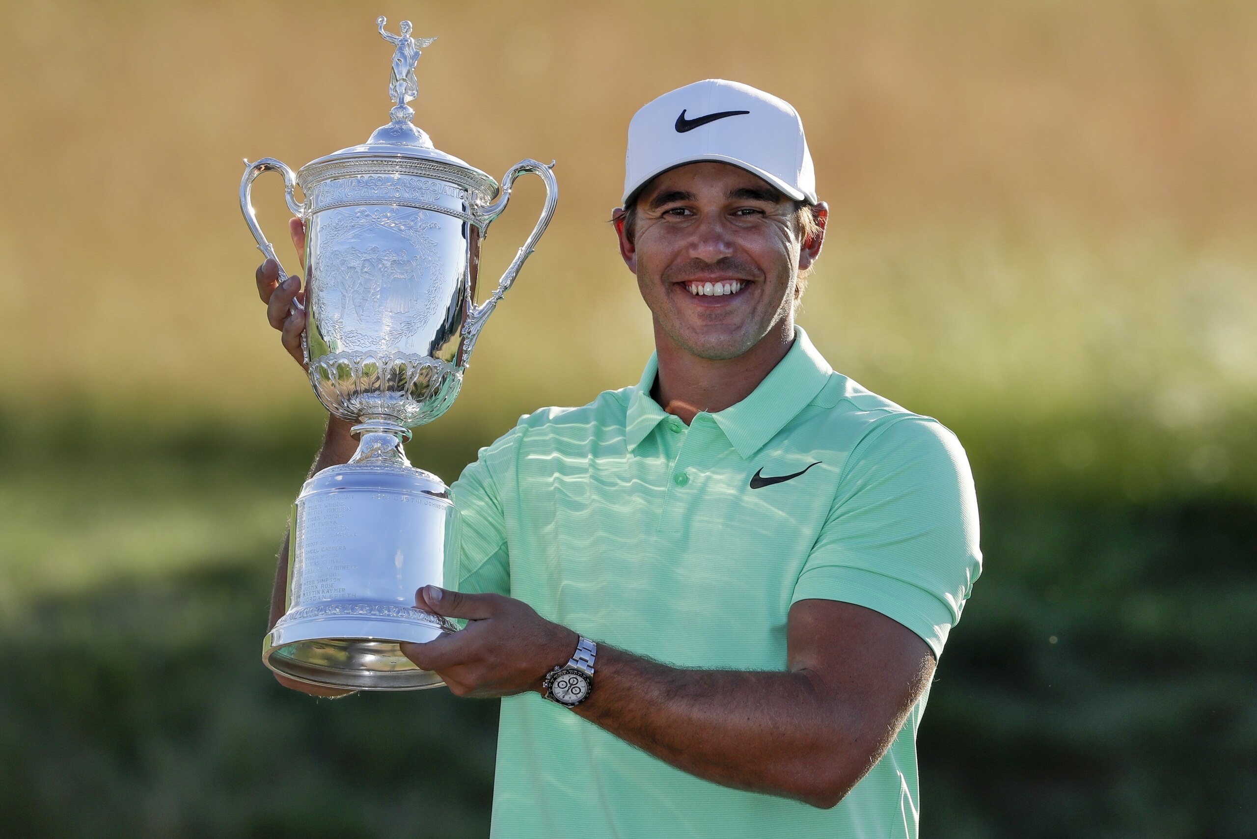 Brooks Koepka poses with the winning trophy after the U.S. Open golf tournament Sunday, June 18, 2017, at Erin Hills in Erin, Wis. (AP Photo/Chris Carlson)