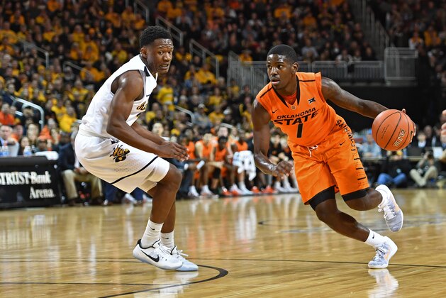 WICHITA, KS - DECEMBER 17:  Guard Jawun Evans #1 of the Oklahoma State Cowboys drives with the ball against guard Daishon Smith #2 of the Wichita State Shockers during the first half on December 17, 2016 at INTRUST Bank Arena in Wichita, Kansas.  (Photo by Peter G. Aiken/Getty Images)