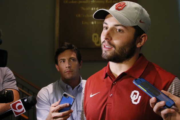 Oklahoma quarterback Baker Mayfield talks with the media following a news conference to announce the retirement of Oklahoma head football coach Bob Stoops and the naming of Lincoln Riley as new head coach, in Norman, Okla., Wednesday, June 7, 2017.  Oklahoma coach Bob Stoops abruptly announced his retirement Wednesday, a stunning offseason move by the 56-year-old future Hall of Famer who led the Sooners to 10 conference championships and a national title in 18 seasons. (AP Photo/Sue Ogrocki)