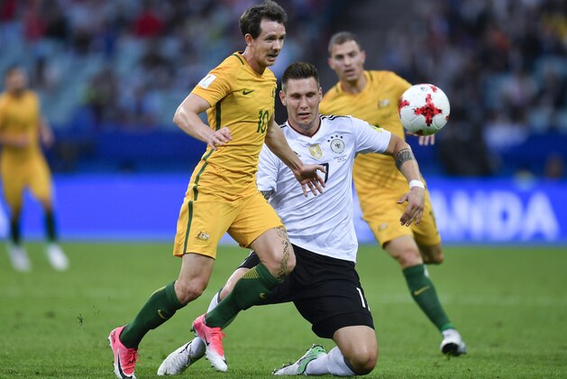 Australia's Robbie Kruse, left, and Germany's Niklas Suele go for the ball during the Confederations Cup, Group B soccer match between Australia and Germany, at the Fisht Stadium in Sochi, Russia, Monday, June 19, 2017. (AP Photo/Martin Meissner)