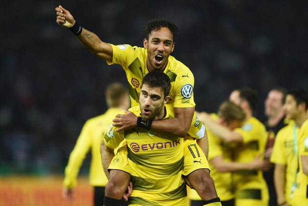 Dortmund's Gabonese striker Pierre-Emerick Aubameyang (top) and Dortmund's Greek defender Sokratis celebrate after Dortmund won the German Cup (DFB Pokal) final football match Eintracht Frankfurt v BVB Borussia Dortmund at the Olympic stadium in Berlin on May 27, 2017. / AFP PHOTO / Christof Stache / RESTRICTIONS: ACCORDING TO DFB RULES IMAGE SEQUENCES TO SIMULATE VIDEO IS NOT ALLOWED DURING MATCH TIME. MOBILE (MMS) USE IS NOT ALLOWED DURING AND FOR FURTHER TWO HOURS AFTER THE MATCH. == RESTRICTED TO EDITORIAL USE == FOR MORE INFORMATION CONTACT DFB DIRECTLY AT +49 69 67880

 /         (Photo credit should read CHRISTOF STACHE/AFP/Getty Images)
