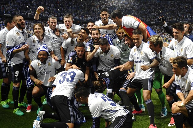 Real Madrid's players celebrate after winning a Spanish La Liga soccer match between Malaga and Real Madrid in Malaga, Spain, Sunday, May 21, 2017. Real Madrid wins the Spanish league for the first time in five years, avoiding its biggest title drought since the 1980s. (AP Photo/Daniel Tejedor)