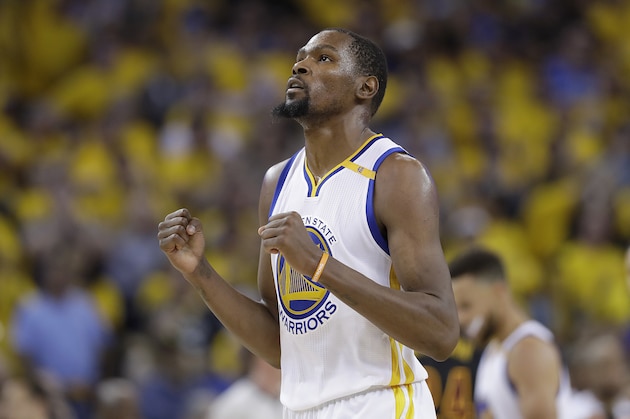 Golden State Warriors forward Kevin Durant reacts after scoring against the Cleveland Cavaliers during the second half of Game 5 of basketball's NBA Finals in Oakland, Calif., Monday, June 12, 2017. (AP Photo/Marcio Jose Sanchez)
