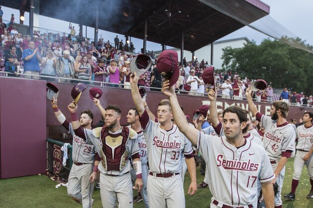 Florida State's Mike Compton (17), Bryant Holzmann (33), Danny De La Calle second from left, and Quincy Nieporte (29) lead their team to tip their caps to their fans after defeating College of Charleston 8-1 in the Tallahassee Regional of the NCAA college baseball tournament in Tallahassee, Fla., Monday, June 1, 2015. Florida State defeated Charleston 8-1. (AP Photo/Mark Wallheiser)