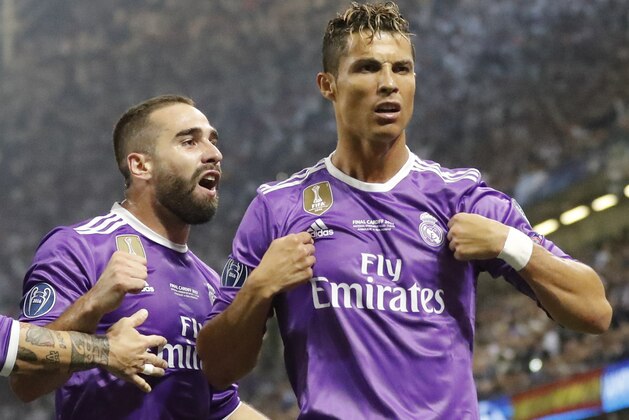 Real Madrid's Cristiano Ronaldo, right, celebrates after scoring the opening goal during the Champions League final soccer match between Juventus and Real Madrid at the Millennium stadium in Cardiff, Wales Saturday June 3, 2017. (AP Photo/Frank Augstein)