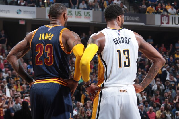 INDIANAPOLIS, IN - APRIL 23:  LeBron James #23 of the Cleveland Cavaliers and Paul George #13 of the Indiana Pacers look on during Game Four of the Eastern Conference Quarterfinals of the 2017 NBA Playoffs on April 23, 2017 at Bankers Life Fieldhouse in Indianapolis, Indiana. NOTE TO USER: User expressly acknowledges and agrees that, by downloading and/or using this photograph, user is consenting to the terms and conditions of the Getty Images License Agreement. Mandatory Copyright Notice: Copyright 2017 NBAE (Photo by Ron Hoskins/NBAE via Getty Images)