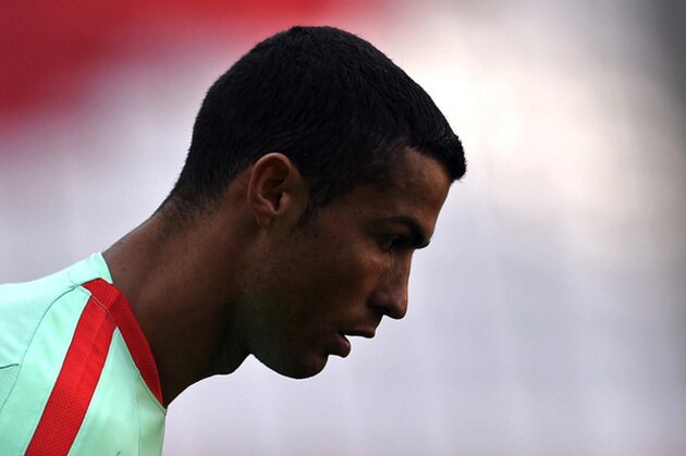 Portugal's Cristiano Ronaldo looks down in the shadow during a training session at the Arena in Kazan, Russia, on Saturday, June 17, 2017. Portugal will play Mexico in a Confederations Cup, Group A soccer match scheduled for Sunday, June 18, 2017. (AP Photo/Martin Meissner)