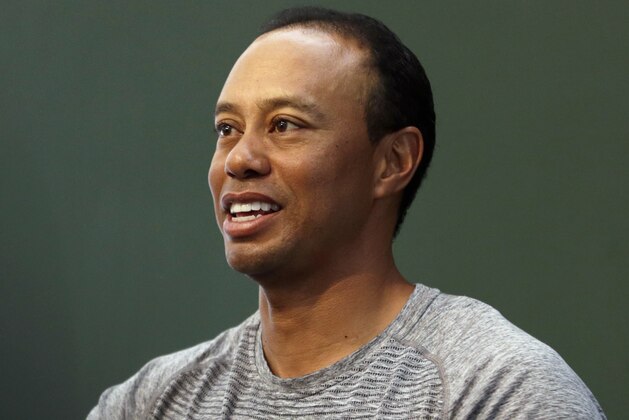 Golfer Tiger Woods prepares to sign copies of his new book at a book signing in New York, Monday, March 20, 2017. (AP Photo/Seth Wenig)
