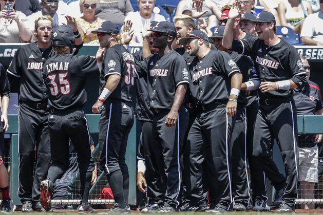 Louisville's Colin Lyman (35) is greeted at the dugout after scoring against Texas A&M on a two-run single by Colby Fitch in the third inning of an NCAA College World Series baseball game in Omaha, Neb., Sunday, June 18, 2017. Louisville won 8-4. (AP Photo/Nati Harnik)