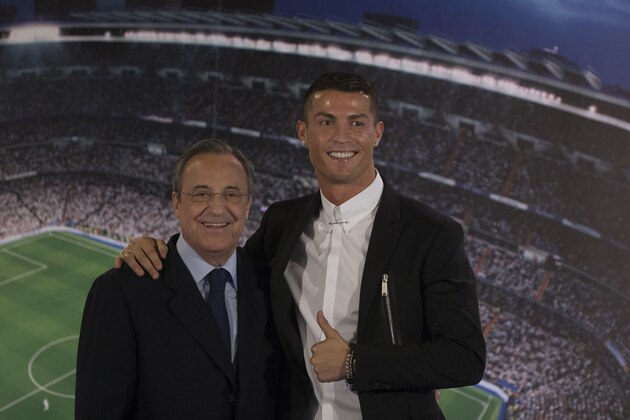 Real Madrid's Cristiano Ronaldo, right, poses with the club's President Florentino Perez after signing a new contract at the Santiago Bernabeu stadium in Madrid, Spain, Monday, Nov. 7, 2016. Real Madrid have extend Ronaldo's contract until June 2021, when the three-time world player of the year will be 36. Financial details were not released, although the star forward is expected to remain the team's top-paid player. (AP Photo/Paul White)