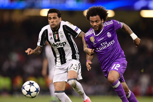 Juventus' Brazilian defender Dani Alves (L) vies with Juventus' Brazilian defender Alex Sandro during the UEFA Champions League final football match between Juventus and Real Madrid at The Principality Stadium in Cardiff, south Wales, on June 3, 2017. / AFP PHOTO / JAVIER SORIANO        (Photo credit should read JAVIER SORIANO/AFP/Getty Images)