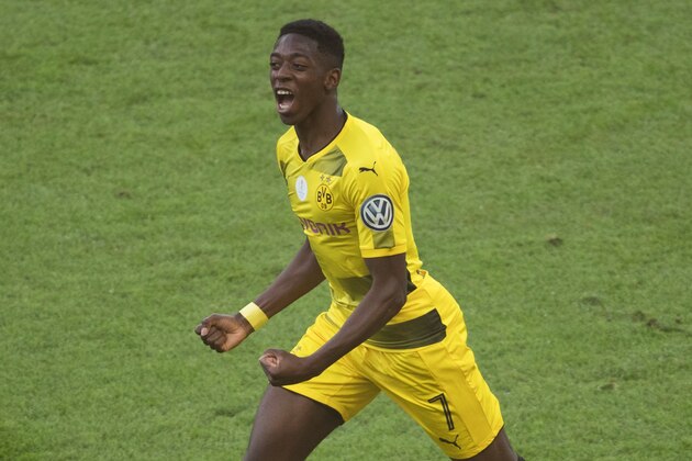 Dortmund's French midfielder Ousmane Dembele celebrates scoring the opening goal during the German Cup (DFB Pokal) final football match Eintracht Frankfurt v BVB Borussia Dortmund at the Olympic stadium in Berlin on May 27, 2017. / AFP PHOTO / Odd ANDERSEN / RESTRICTIONS: ACCORDING TO DFB RULES IMAGE SEQUENCES TO SIMULATE VIDEO IS NOT ALLOWED DURING MATCH TIME. MOBILE (MMS) USE IS NOT ALLOWED DURING AND FOR FURTHER TWO HOURS AFTER THE MATCH. == RESTRICTED TO EDITORIAL USE == FOR MORE INFORMATION CONTACT DFB DIRECTLY AT +49 69 67880

 /         (Photo credit should read ODD ANDERSEN/AFP/Getty Images)