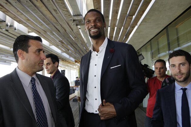 NBA basketball player Chris Bosh, center, leaves a news conference, Wednesday, May 3, 2017, in Miami. It was announced that musician Marc Anthony will perform in the halftime show of the International Champions Cup soccer match of El Clasico Miami between Real Madrid C.F. and FC Barcelona on July 29 at Hard Rock Stadium in Miami Gardens, Fla. Bosh is an ambassador for El Clasico Miami. (AP Photo/Lynne Sladky)