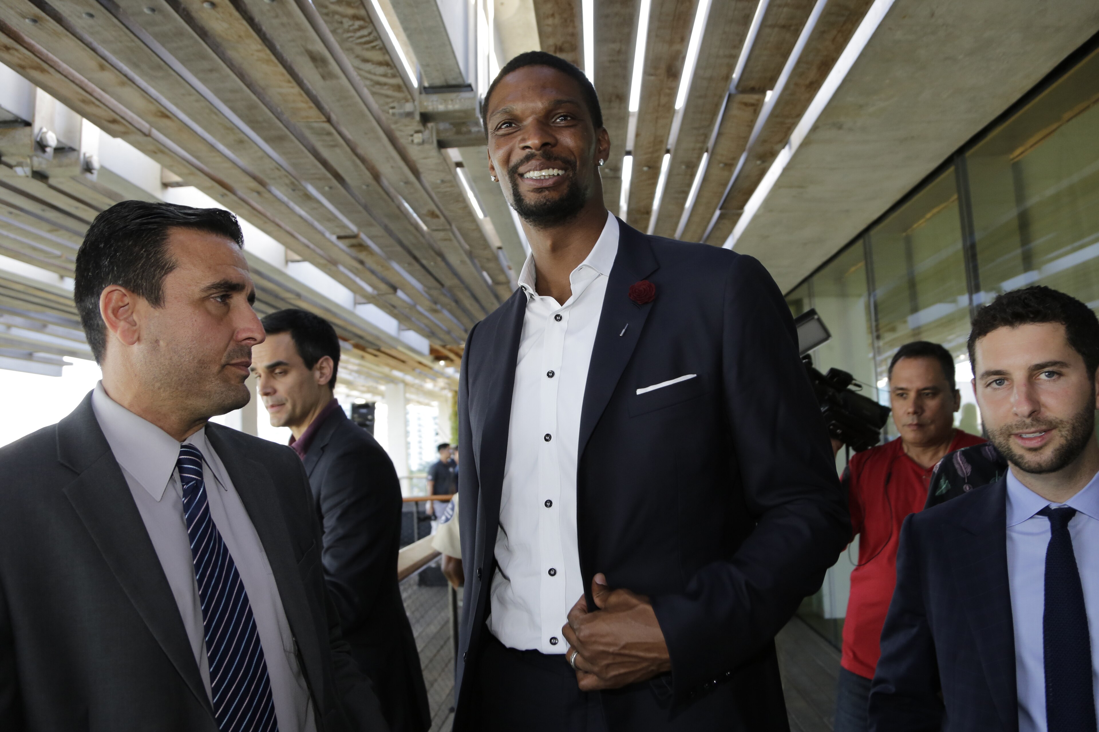 NBA basketball player Chris Bosh, center, leaves a news conference, Wednesday, May 3, 2017, in Miami. It was announced that musician Marc Anthony will perform in the halftime show of the International Champions Cup soccer match of El Clasico Miami between Real Madrid C.F. and FC Barcelona on July 29 at Hard Rock Stadium in Miami Gardens, Fla. Bosh is an ambassador for El Clasico Miami. (AP Photo/Lynne Sladky)
