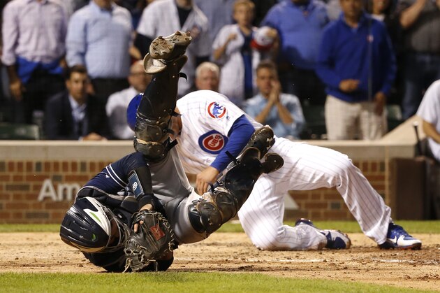 San Diego Padres catcher Austin Hedges rolls on the ground still holding the ball after Hedges tagged out Chicago Cubs' Anthony Rizzo during a collision at home during the sixth inning of a baseball game Monday, June 19, 2017, in Chicago. (AP Photo/Charles Rex Arbogast)