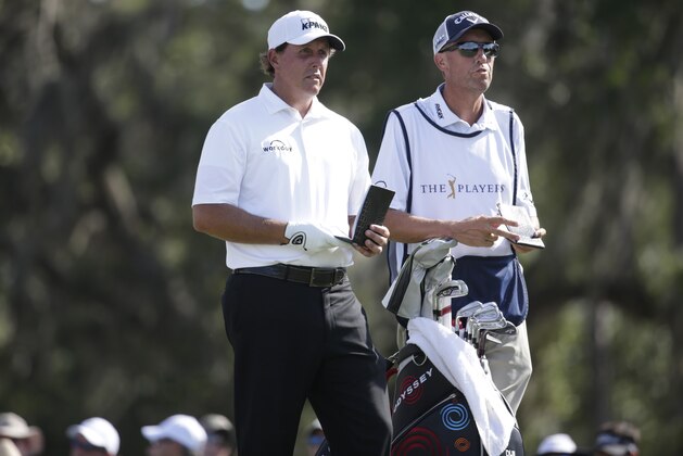 Phil Mickelson, left, stands with his caddie Jim Mackay, right, on the 12th tee during the second round at The Players Championship golf tournament, Friday, May 12, 2017, in Ponte Vedra Beach, Fla. (AP Photo/Lynne Sladky)