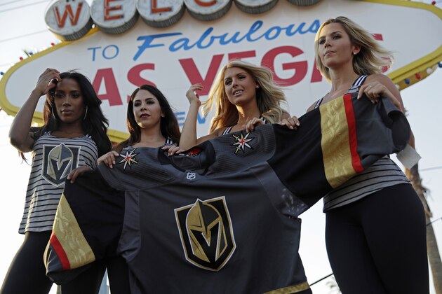 Models unveil the Vegas Golden Knights' new hockey jersey Tuesday, June 20, 2017, in Las Vegas. The Knights are an NHL hockey expansion team. (AP Photo/John Locher)