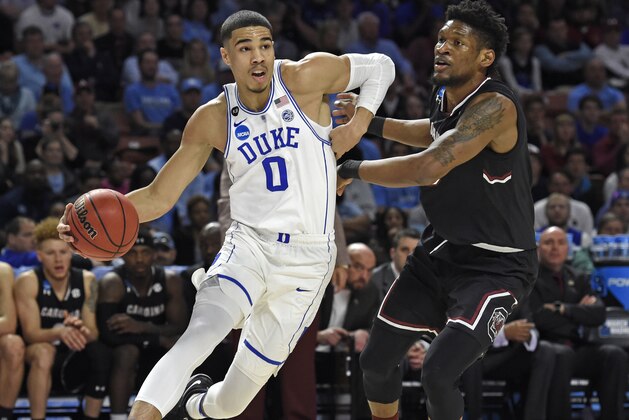 FILE - In this March 19, 2017, file photo, Duke's Jayson Tatum, left, drives past South Carolina's Chris Silva during the first half in a second-round game of the NCAA men's college basketball tournament, in Greenville, S.C. Tatum spent one season at Duke and is expected to be a top-five pick in Thursday's NBA draft. (AP Photo/Rainier Ehrhardt, File)