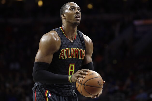 FILE - In this March 29, 2017, file photo, Atlanta Hawks' Dwight Howard prepares to shoot a free throw during the team's NBA basketball game against the Philadelphia 76ers in Philadelphia. A person familiar with the situation says the Charlotte Hornets have reached an agreement to acquire center Howard from the Hawks. The Hawks are sending Howard and the No. 31 overall pick in Thursday's NBA draft to Charlotte for center Miles Plumlee, shooting guard Marco Belinelli and the 41st pick, the person told The Associated Press on condition of anonymity Tuesday, June 20, because the trade is not yet official. (AP Photo/Matt Slocum, File)