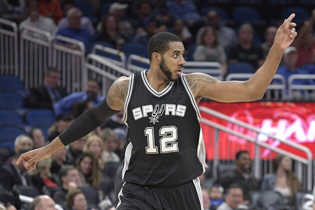 San Antonio Spurs forward LaMarcus Aldridge (12) celebrates after scoring during the first half of the team's NBA basketball game against the Orlando Magic in Orlando, Fla., Wednesday, Feb. 15, 2017. (AP Photo/Phelan M. Ebenhack)