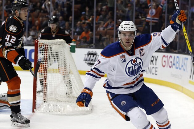 Edmonton Oilers center Connor McDavid, right, reacts after scoring against Anaheim Ducks defenseman Josh Manson, left, during the first period of an NHL hockey game in Anaheim, Calif., Wednesday, March 22, 2017. (AP Photo/Alex Gallardo)