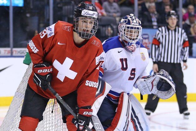 TORONTO, ON - JANUARY 2:  Tyler Parsons #1 of Team USA protects the corner with Nico Hischier #18 of Team Switzerland on his doorstep during a QuarterFinal game at the 2017 IIHF World Junior Hockey Championships at Air Canada Centre on January 2, 2017 in Toronto, Ontario, Canada. Team USA defeated Team Switzerland 3-2. (Photo by Claus Andersen/Getty Images)