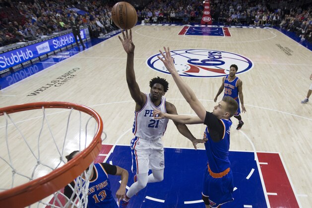 PHILADELPHIA, PA - JANUARY 11: Joel Embiid #21 of the Philadelphia 76ers shoots the ball against Kristaps Porzingis #6 of the New York Knicks in the first half at the Wells Fargo Center on January 11, 2017 in Philadelphia, Pennsylvania. The Sixers defeated the Knicks 98-97. NOTE TO USER: User expressly acknowledges and agrees that, by downloading and or using this photograph, User is consenting to the terms and conditions of the Getty Images License Agreement. (Photo by Mitchell Leff/Getty Images)