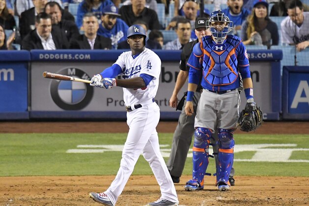 Los Angeles Dodgers' Yasiel Puig slowly leaves the plate after hitting a three-run home run, while New York Mets catcher Travis d'Arnaud, right, watches along with home plate umpire Lance Barksdale during the fourth inning of a baseball game, Wednesday, June 21, 2017, in Los Angeles. (AP Photo/Mark J. Terrill)