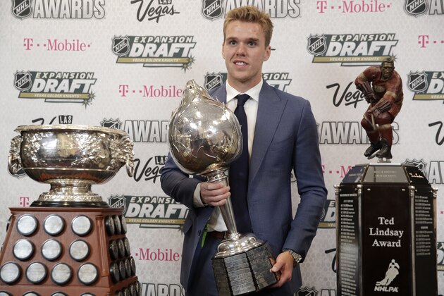 Connor McDavid of the Edmonton Oilers poses with the Art Ross Trophy, left, the Hart Memorial Trophy, center, and the Ted Lindsay Award after winning the honors during the NHL Awards, Wednesday, June 21, 2017, in Las Vegas. (AP Photo/John Locher)