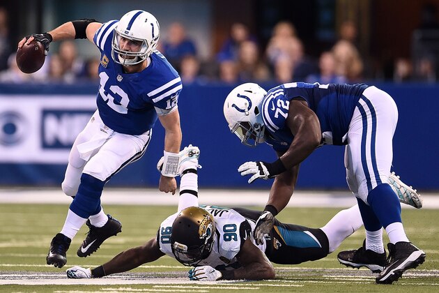 INDIANAPOLIS, IN - JANUARY 01:  Andrew Luck #12 of the Indianapolis Colts avoids a tackle by Malik Jackson #90 of the Jacksonville Jaguars during a game at Lucas Oil Stadium on January 1, 2017 in Indianapolis, Indiana.  The Colts defeated the Jaguars 24-20.  (Photo by Stacy Revere/Getty Images)