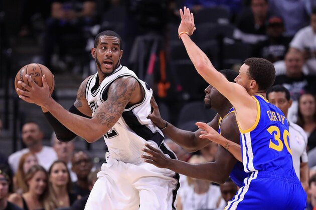 SAN ANTONIO, TX - MAY 20:  LaMarcus Aldridge #12 of the San Antonio Spurs handles the ball against Stephen Curry #30 and Draymond Green #23 of the Golden State Warriors in the first half during Game Three of the 2017 NBA Western Conference Finals at AT&T Center on May 20, 2017 in San Antonio, Texas. NOTE TO USER: User expressly acknowledges and agrees that, by downloading and or using this photograph, User is consenting to the terms and conditions of the Getty Images License Agreement.  (Photo by Ronald Martinez/Getty Images)